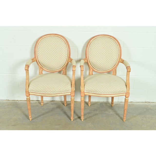 A gorgeous pair of French Regency Louis XVI style armchairs or dining captain chairs By Baker Furniture USA, Circa 1960s...