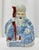 A character-rich porcelain figure depicting a smiling, long-bearded immortal—likely Shoulao (the Daoist god of...