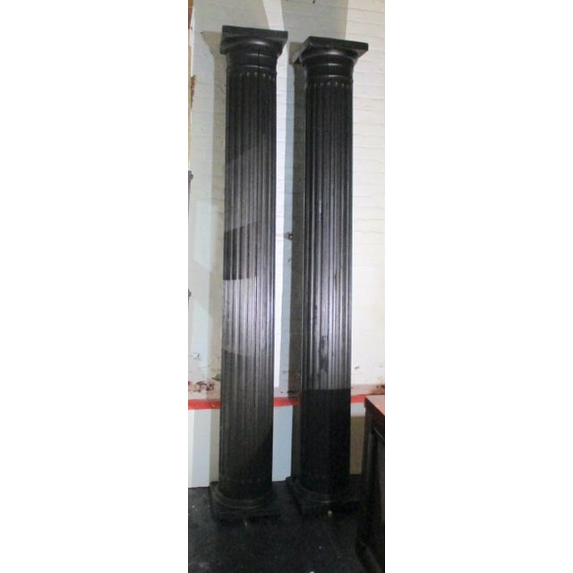 Antique Victorian wooden fluted columns. 8' 2" tall (98" tall) and 14" square footed bases. Hollow pine wooden shafts with...