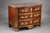 Chest of drawers in violet wood, the curved front opening to five drawers in three rows, the top in red marble from...