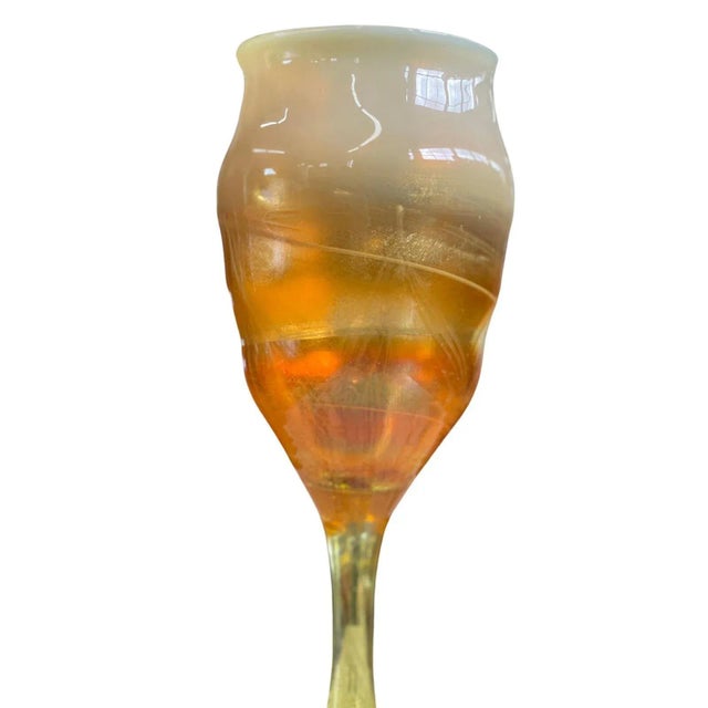 Louis Comfort Tiffany iridescent and gold favrile glass goblet. Paper label on base. Dimensions: 9.75"H x 3.5"D