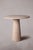 Our travertine dining table features a sturdy pedestal base and a round tabletop, exuding timeless elegance and...