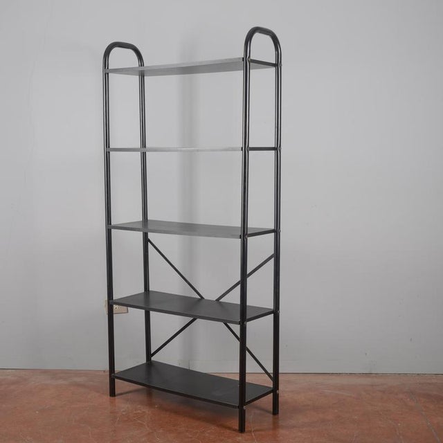 A functional open bookcase, representative of the essential and practical design of the 1990s. This vintage piece fits...