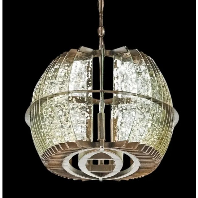 A stunning massive chandelier by Curry& Company. The chandelier is a true eye catching show stopper with plane after plane...