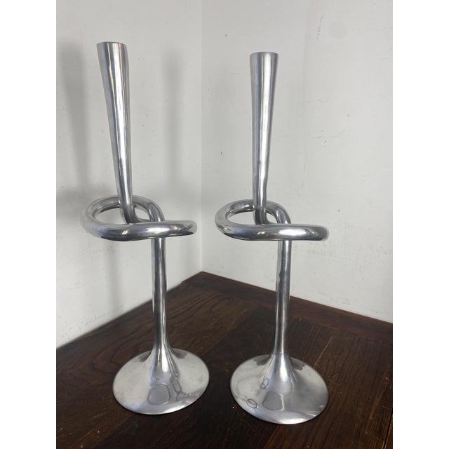 In a Brutalist style with a sculptural design, this elegant pair of large cast aluminum candlesticks was made in Italy in...