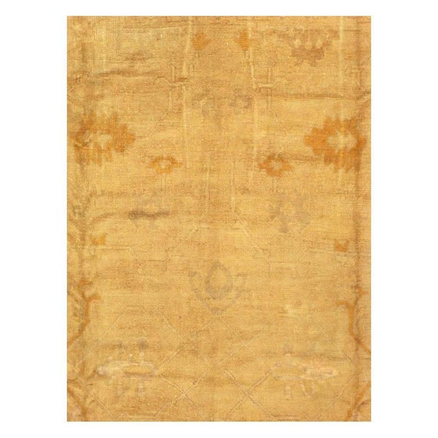An antique Turkish Oushak large room size carpet in square format handmade during the early 20th century. The tone-on-tone...