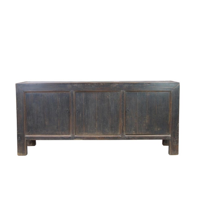 This vintage sideboard is made from reclaimed solid wood featuring a weathered, dark charcoal brown finish with rustic...