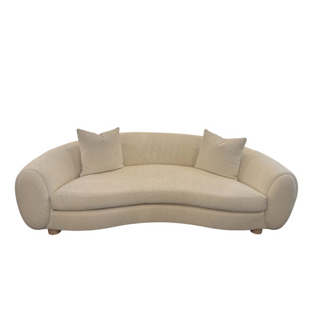 97"W x 47"D x 31"H Tight back sofa finished in a lush white polyester boucle with a pecan cylindrical foot, the Eastman is...