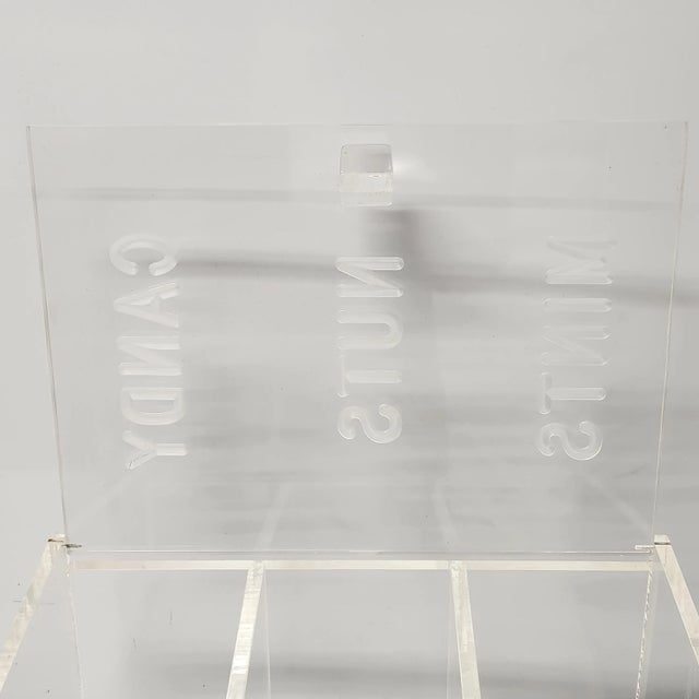 A vintage clear acrylic serving box with three divided compartments labeled Candy, Nuts, and Mints. The lid is hinged and...