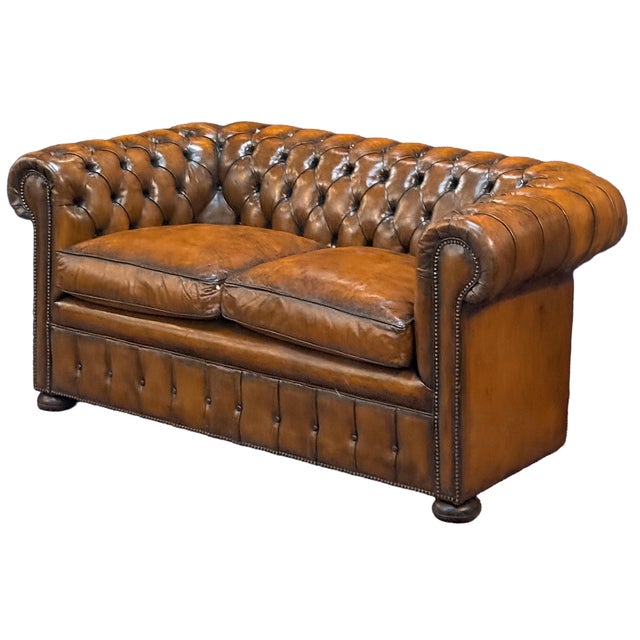 A fine Chesterfield two-seater sofa upholstered in original patinated chestnut leather from Edwardian era England -...