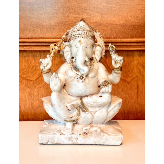 A finely carved marble statue of Ganesh circa 19th century from India. The semi-elephant semi-human Hindu deity is also...