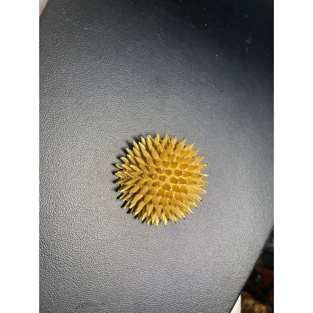 sea urchin" starburst brooch by DeNicola features a domed, atomic-style motif composed of textured, gold-tone tapered...