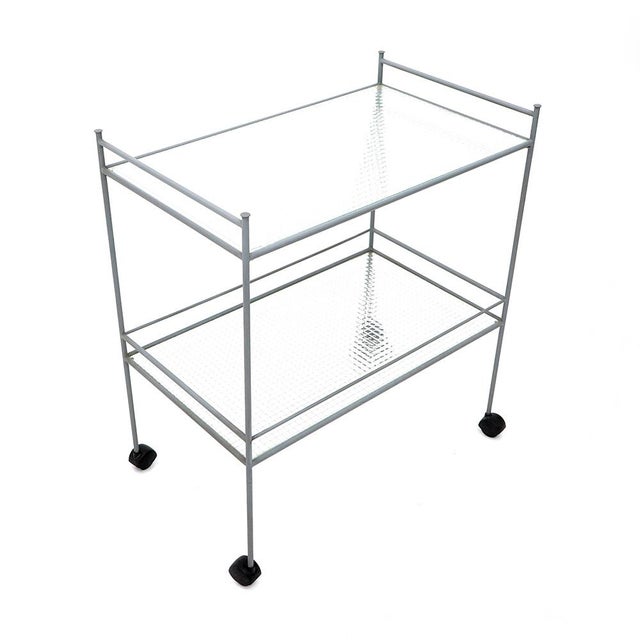 Italian-made trolley produced in the 1980s. Gray painted metal structure. Two shelves in wired glass. Plastic wheels. Good...