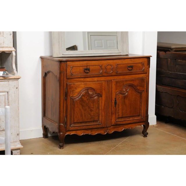 A French Louis XV period mid-18th century walnut buffet from Provence with single drawer and two doors. Created in...