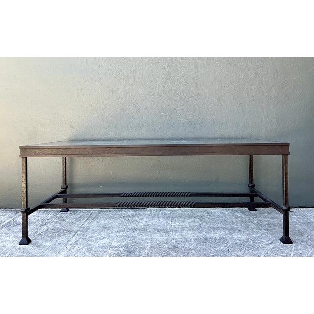 This substantial coffee table is a masterclass in artisanal metalwork, drawing deep inspiration from Spanish Revival and...