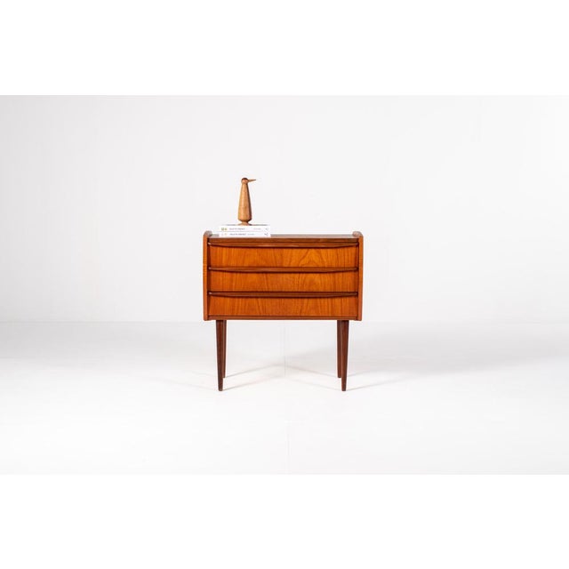 Beautiful Danish teak chest of drawers from the mid century period. The piece has a warm, rich teak color with a stunning...