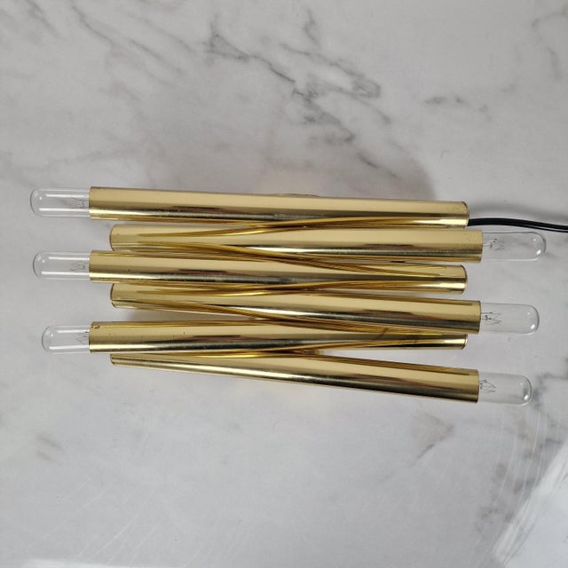 Sculptural vintage wall lamp featuring six light points, executed in brass-toned metal and designed in the distinctive...