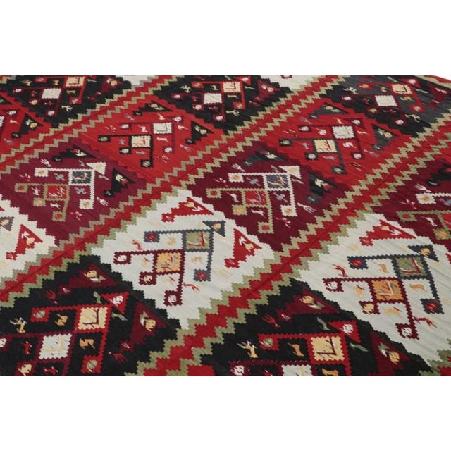 Handwoven in wool circa 1950-1960, This 11x11 vintage Persian kilim is a rare work from the Rug & Kilim collection. On the...