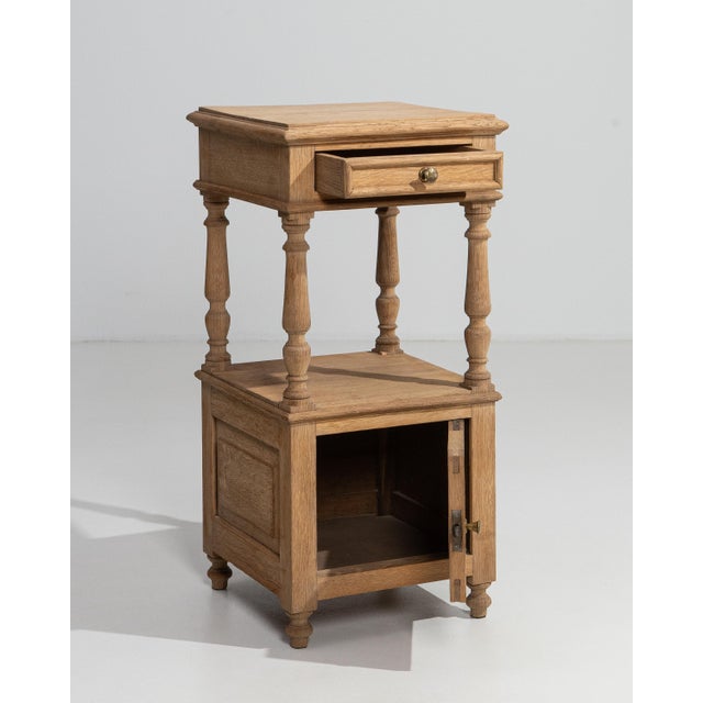 Rendered in warm French oak, this refined side table speaks to the quiet sophistication of late nineteenth-century...