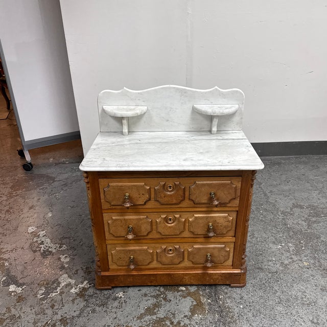 Design Plus Gallery presents an Antique Oak Washstand with Marble Top and Backsplash. This traditional piece is...