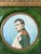 A fine antique French miniature portrait depicting Napoleon Bonaparte in imperial uniform, finely rendered in profile with...
