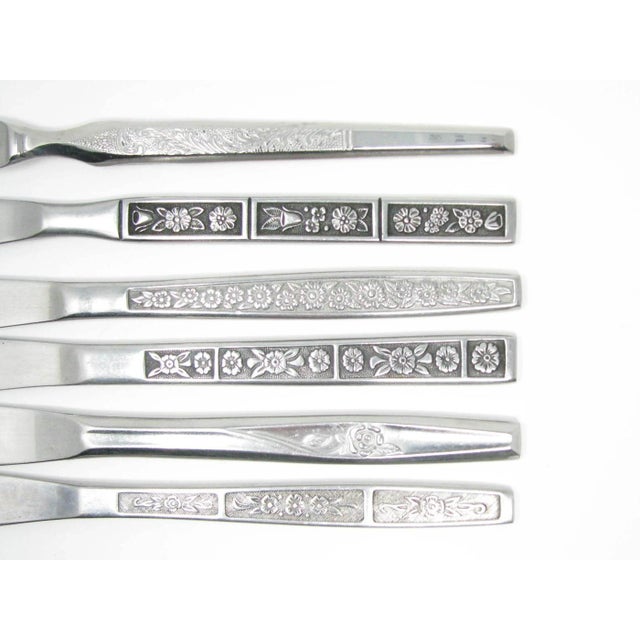 Vintage mix match stainless steel flatware set with floral designs consisting of 10 place settings and 4 serving pieces...