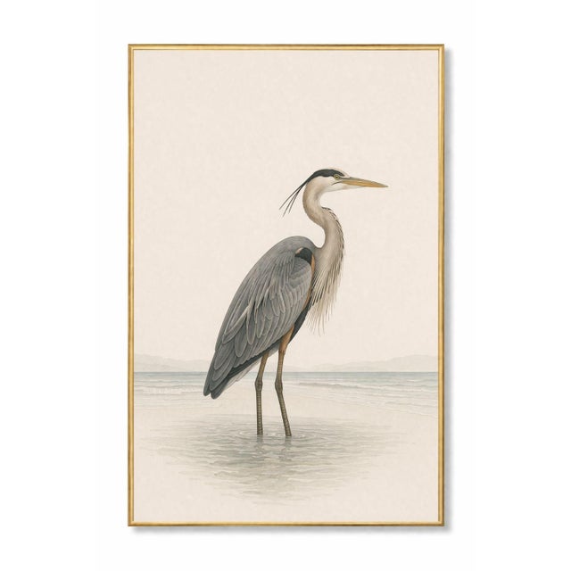 Refined coastal artwork featuring a great blue heron standing in shallow water, rendered with delicate feather detail and...