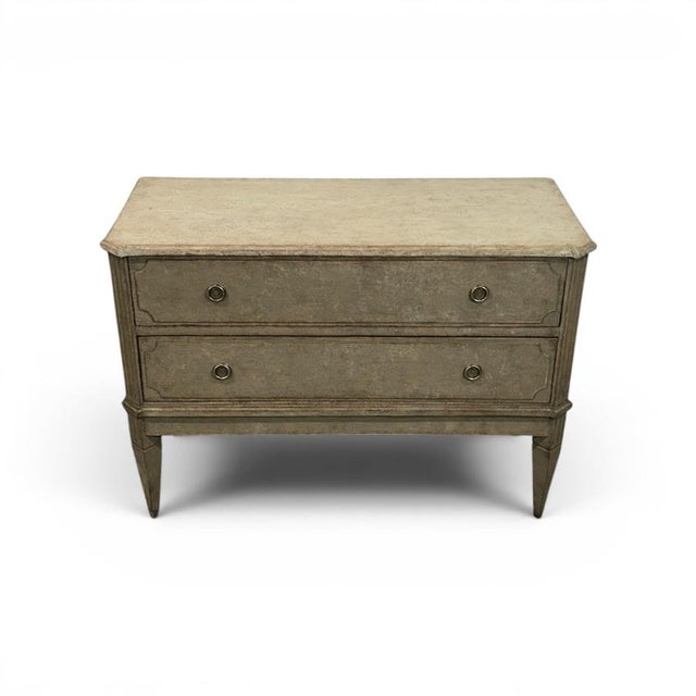 A classic pair of antique Gustavian-style chests of drawers in a warm and dark grey finish. The top is antique white. A...