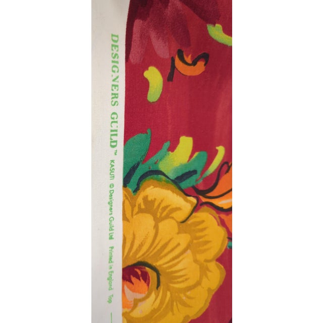 Genuine Designers Guild "Kasuti" printed cotton — a bold, richly saturated floral on a deep red ground, with marigolds,...