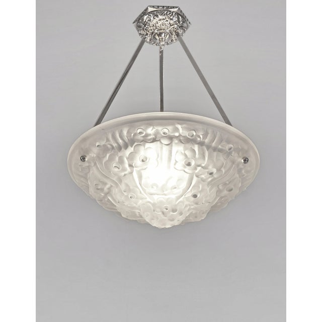 Degué A signed French art deco pendant light made around 1930 in nickel plated bronze or solid brass holding a bowl by...