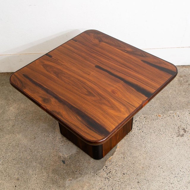 Rosewood side table by Danish designer. The top surface sits on a pedestal base.