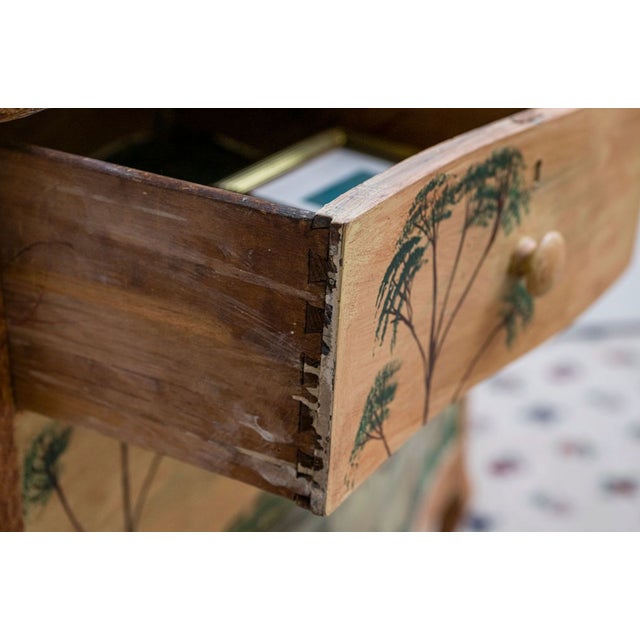 A wonderfully whimsical antique hand-painted chest of drawers featuring an uncommon panoramic landscape that extends...