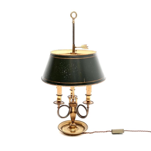A beautiful antique French brass and tole bouillotte table lamp, made in France and dating from around the 1920’s. It is...