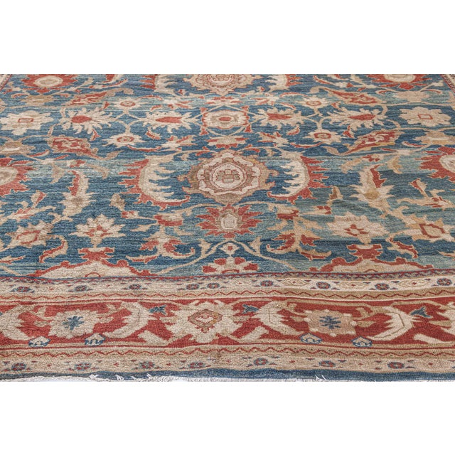 The main field of this blue Persian rug, made circa 1890, is occupied by an allover botanical grid with palmettes and...