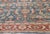 The main field of this blue Persian rug, made circa 1890, is occupied by an allover botanical grid with palmettes and...