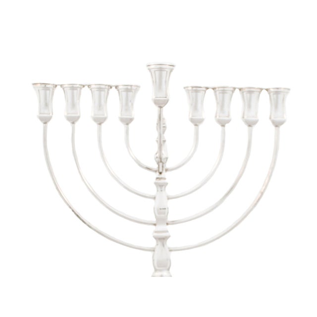 Being offered is a new sterling silver menorah. Made in Israel it is modern and has a masculine feel with its straight...