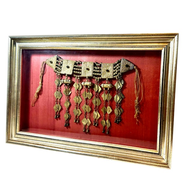 A vintage Turkoman ethnic tribal headpiece, beautifully presented in a custom silver gilt frame with a rich pomegranate...
