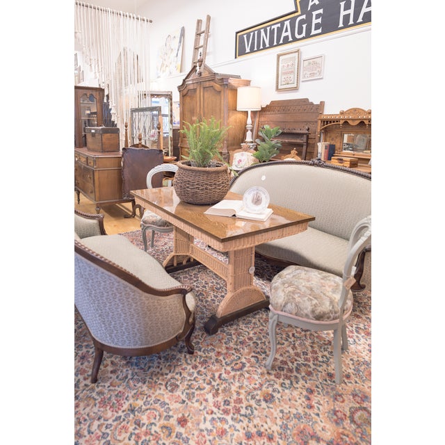 A very handsome Heywood-Wakefield dining table with wicker legs, apron, and stretcher as well as a freshly refinished oak...