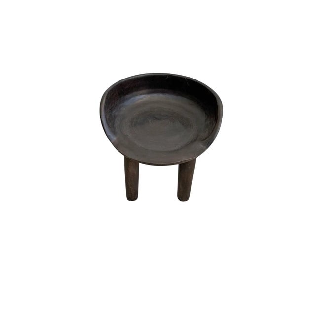 This wonderfully sculptural chair was crafted from a single block of mango wood. The chair sits on 4 slender legs. Its...