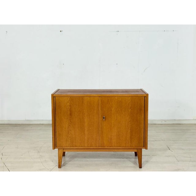 For sale is this beautiful 1960s chest of drawers, distinguished by its warm oak wood and timeless design. The piece is in...