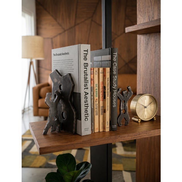 The bookends feature abstract, fluid geometric silhouettes and front-mounted stylized dancing figures heavily inspired by...
