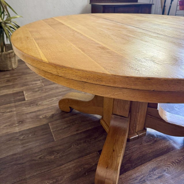 Newly refinished vintage or antique quarter-sawn oak round pedestal dining table, featuring an Empire Revival style that...
