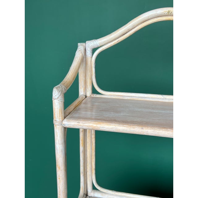 Bamboo and Rattan etagere/bookcase featuring a cabinet with doubles doors and middle shelving Dimensions: 30” Width x...