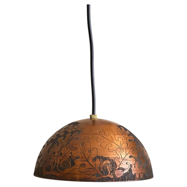An Italian pendant light from the Turin workshop of Victor Cerrato, dating to the 1960s. The domed copper shade is etched...