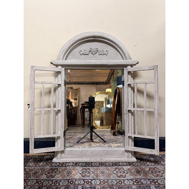Charming Italian-style dome top window design mirror featuring a wooden frame with a whitewashed finish. The shutter-style...