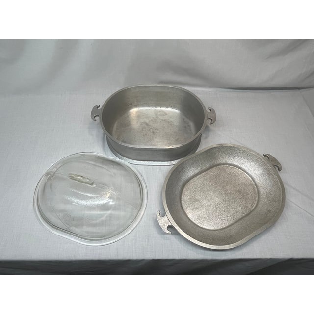 into your kitchen with this highly collectible, authentic Guardian Service 3-Piece Double Oval Roaster Set. Manufactured...