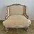 early 20th century French Louis XV style oversized carved wood Bergeres. The armchair painted blue with silver gilt...