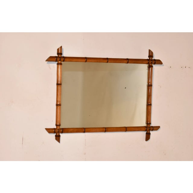 Late 19th century faux bamboo framed mirror from France. The frame is made from cherry and is hand turned to resemble...