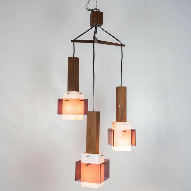 Chandelier pendant, 3 lights. It has a special wooden structure with shade in white and purple Acrylic glass. Created by...