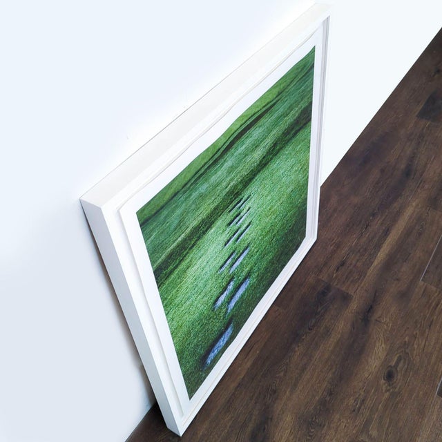 Framed print featuring a green landscape and stone path. The vivid print comes in a modern white frame. Brand: Kimberley...